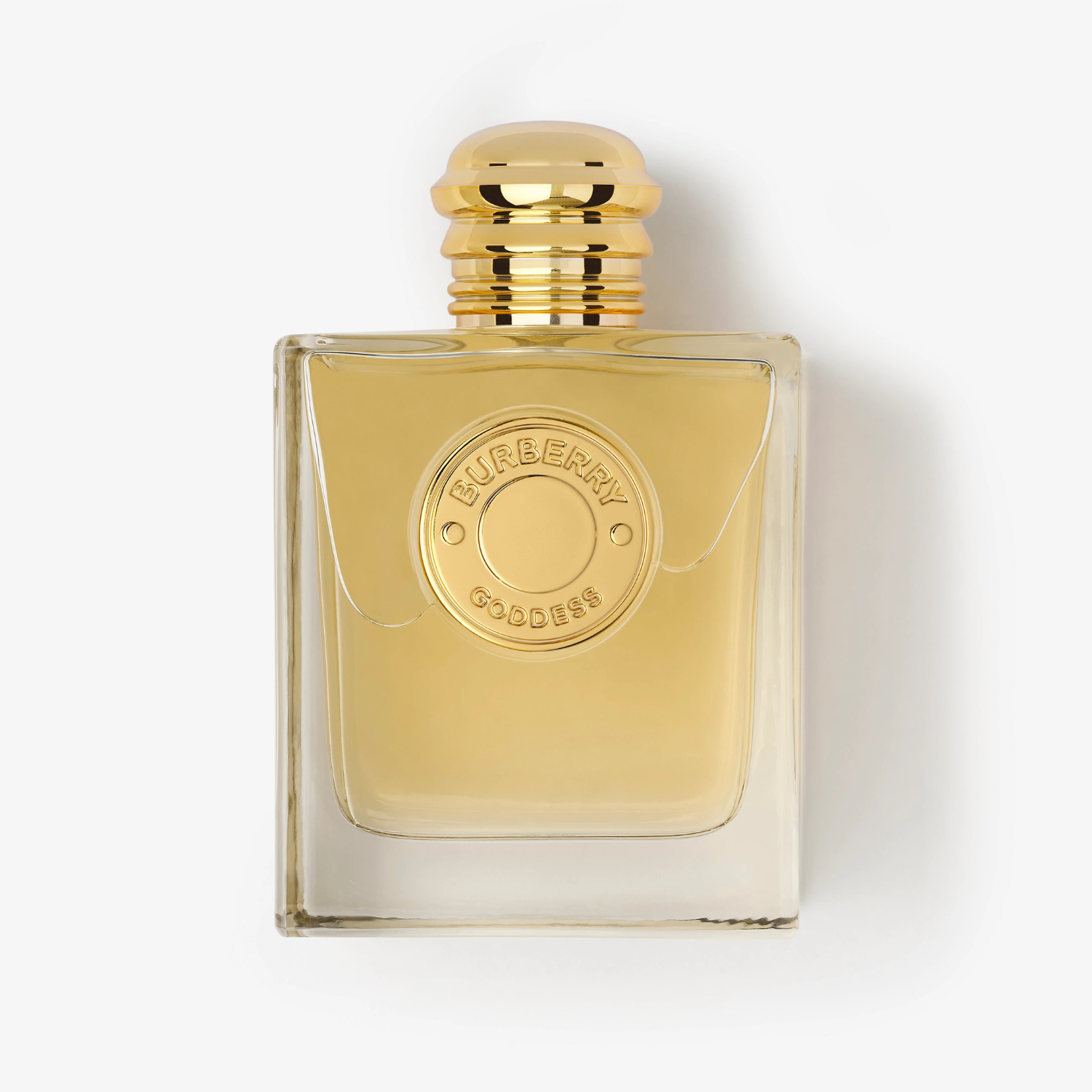 Frasco do perfume Burberry Goddess deitado sobre fundo branco. O design retangular com tampa dourada e líquido dourado em destaque transmite elegância minimalista.